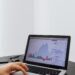 A person analyzing Bitcoin energy consumption data on a laptop with graphs and charts.