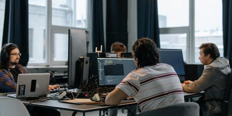 Developers collaborating on Ethereum applications at a tech workspace.