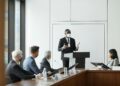 A group of bank representatives discuss stablecoin regulations in a conference room.