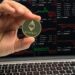 Crypto whales monitoring Ethereum trends on digital devices with financial graphs displayed.
