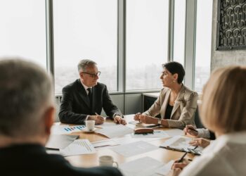 Banks discussing regulatory delays for cryptocurrency legislation in a boardroom setting.