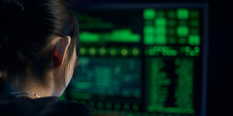 A cybersecurity analyst reviews a computer screen displaying a Linux vulnerability report.