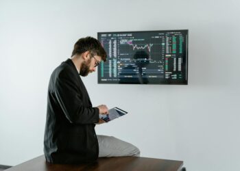 A financial professional analyzing cryptocurrency data on a digital screen.