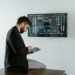 A financial professional analyzing cryptocurrency data on a digital screen.