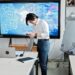 Military personnel and tech executives discuss AI technology in a conference room setting.