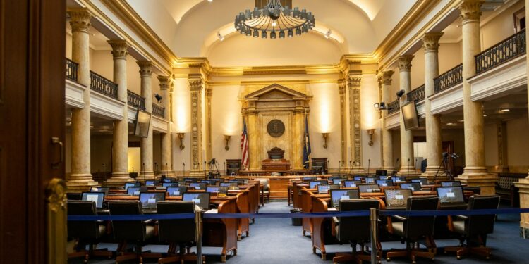 Senators discussing legislation in the chamber, with charts on prediction markets displayed.