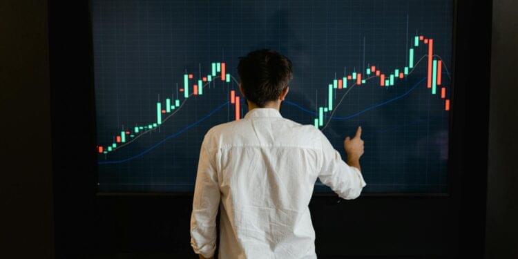 A computer screen displaying cryptocurrency graphs and trading charts.