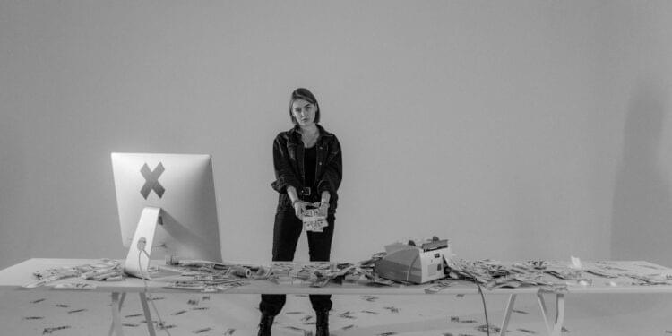 Coins and cash on a table with a police badge, highlighting cryptocurrency theft.